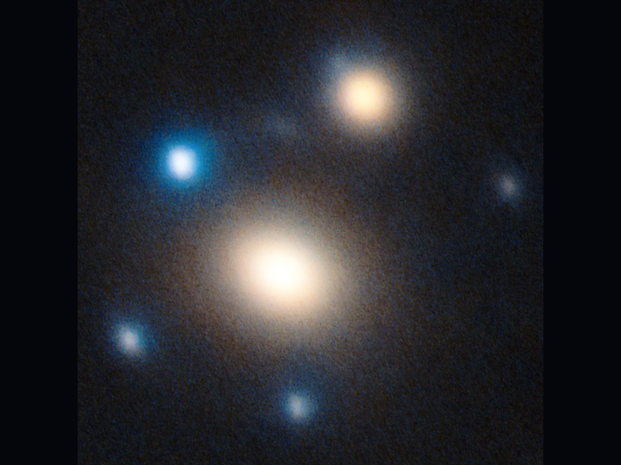 Large Binocular Telescope image of SN Winny: two warm-toned lens galaxies at centre with five bluish copies of the supernova arranged around them